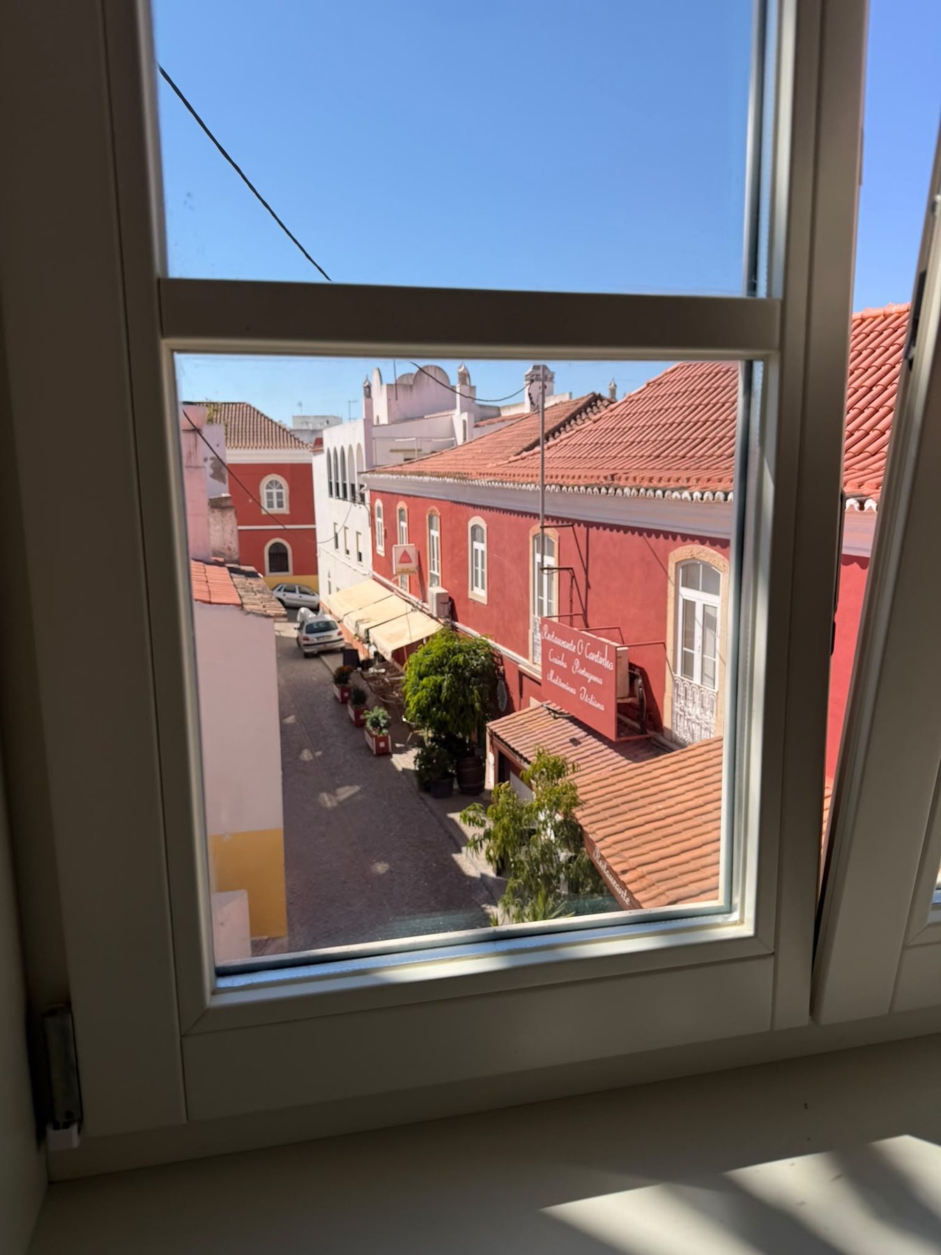 Casa da Coroa — view from a first-floor window over the rooftops of Alcantarilha