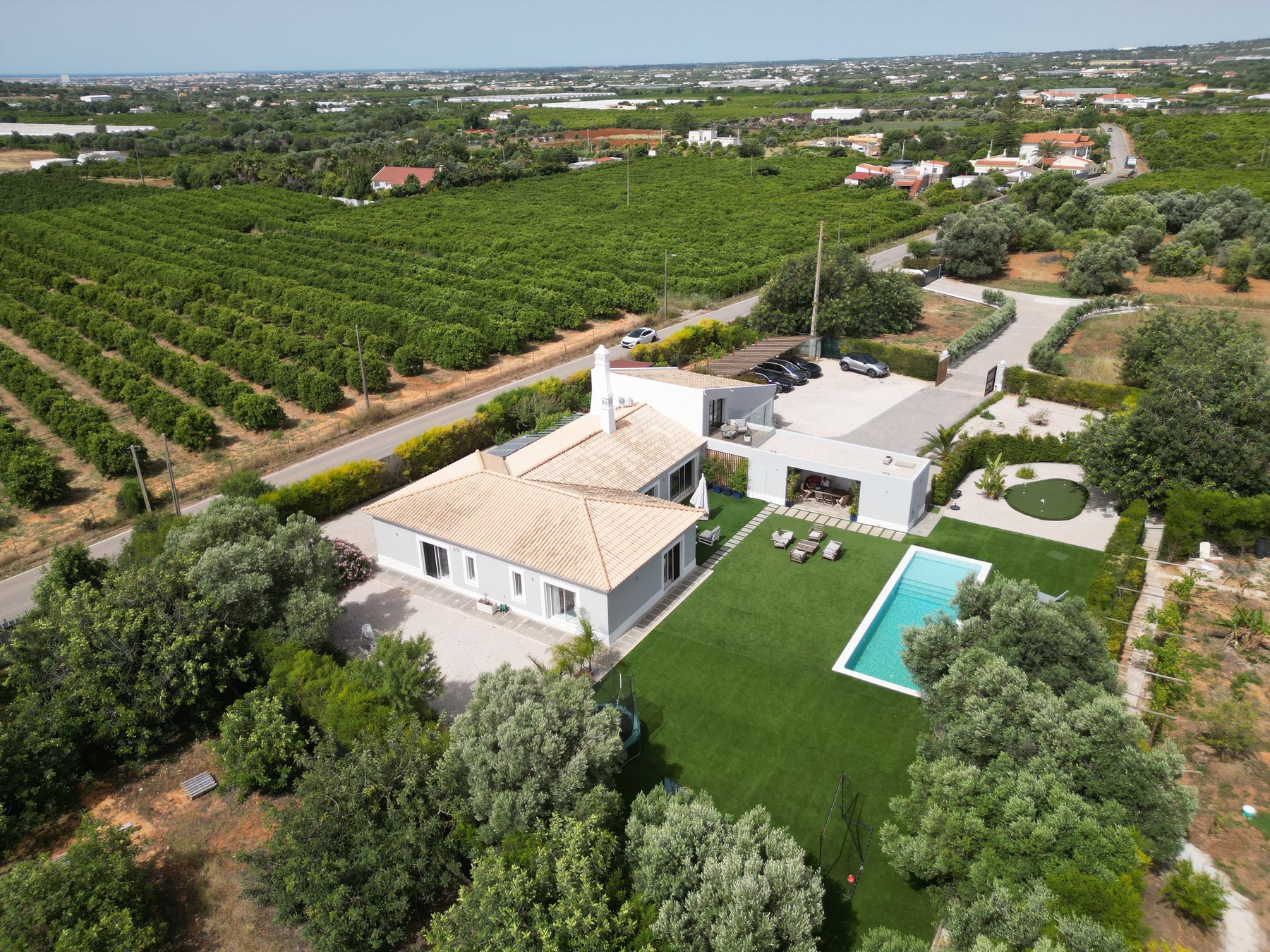 Vale da Rosa, Estoi — aerial view of the house, pool and surrounding olive groves