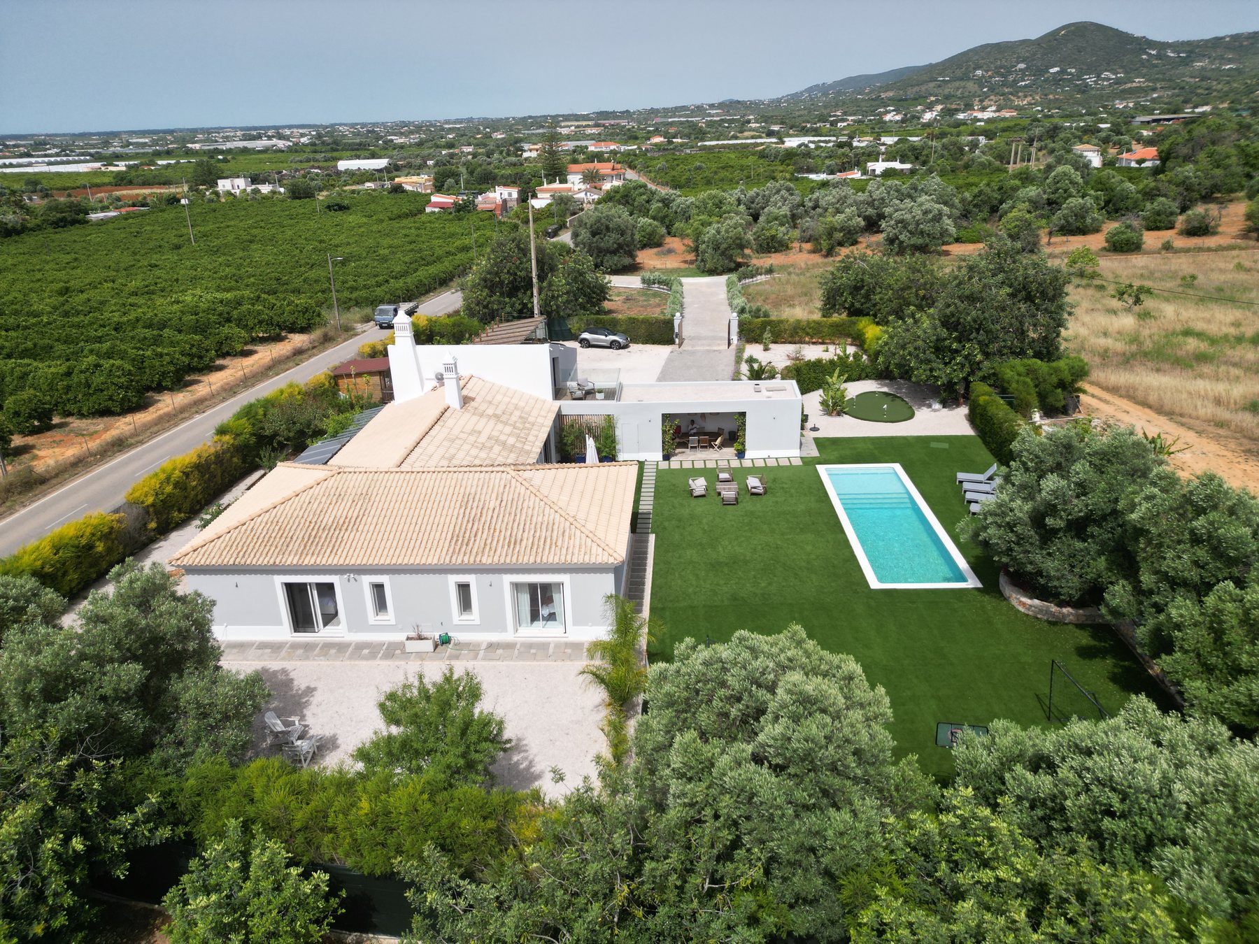 Vale da Rosa, Estoi — aerial view across the 2.02 hectare plot showing olive groves, the surrounding agricultural land, and the line of cypress trees marking the inner garden