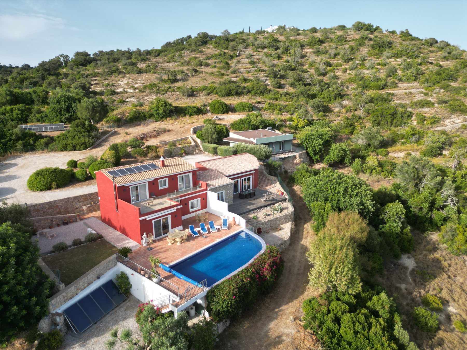 Estoi country estate — aerial of the red houses, pool and hillside plot