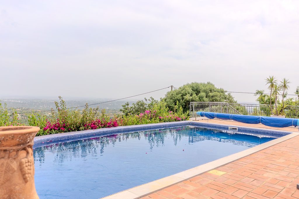 Estoi country estate — pool with views across the countryside to the coast