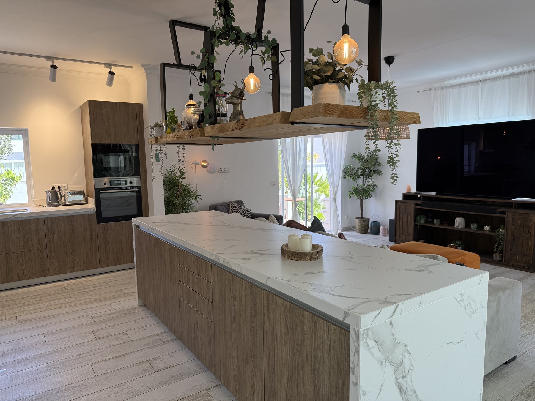 Open-plan kitchen with marble island opening to the dining area